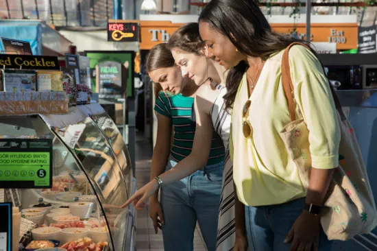 Students looking at food through a counter